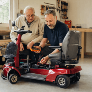 Two men diagnosing a scooter with a multimeter.